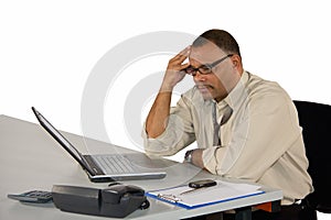 Concentrated businessman sitting at laptop