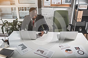 Concentrated businessman is working on notebook in office