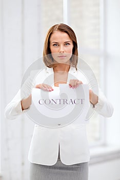 Concentrated businesswoman tearing contract