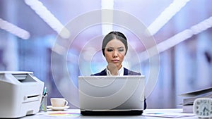 Concentrated businesswoman working laptop in office, corporate career, manager