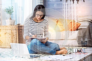 Concentrated busy woman making notes at home