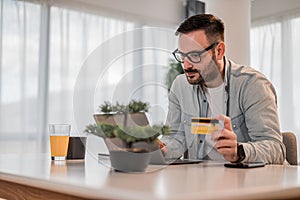 Concentrated casual business man, checking his account balance