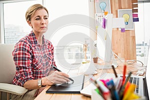 Concentrated casual designer working with digitizer photo