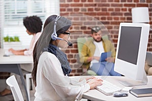 Concentrated casual young woman using computer