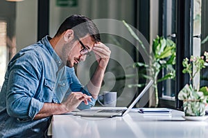 Concentrated caucasian employee, stuck on a problem at work