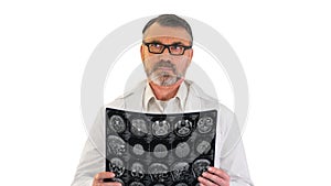 Concentrated doctor examining head brain x ray picture on white