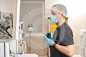 Concentrated doctor performing endoscopic ultrasound in procedure room