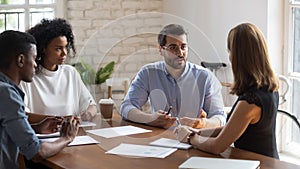 Concentrated employees listening to boss project instruction.