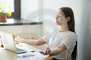 Concentrated female meditating in mudra position