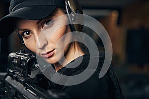 Concentrated female shooter aiming at a target