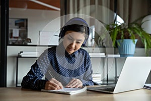 Concentrated female student studying remotely on online courses.