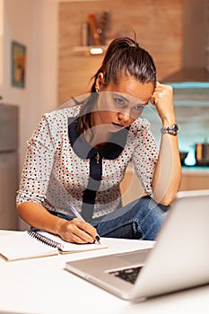 Concentrated freelance woman working overtime