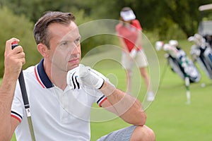 Concentrated golfer taking shot at golf course