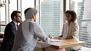 Focused male employers interviewing african american candidate.