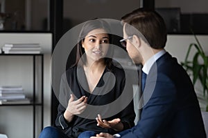 Concentrated indian female introducing herself to hr on job interview photo