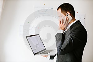 concentrated investment stock broker talking on phone in office