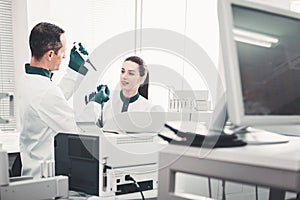 Concentrated laboratory workers checking analyses