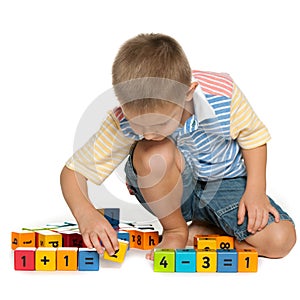 Concentrated little boy with blocks on the floor