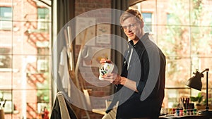 Concentrated Male Artist Working on Colourful Bold Design of Sneakers in Loft Studio. Fashion