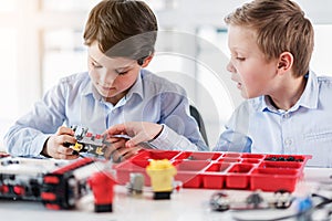 Concentrated male children keeping lego