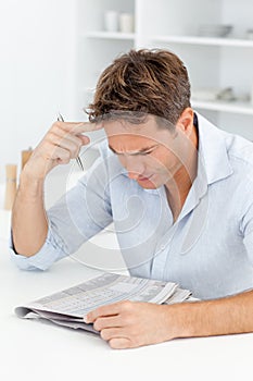 Concentrated man doing a cryptic crossword