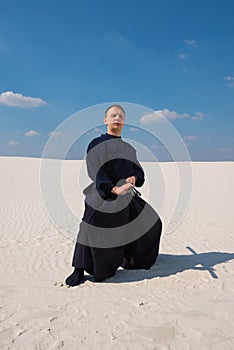 Concentrated man in traditional Japanese clothes took the position