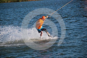 Concentrated man trains on a wakeboard