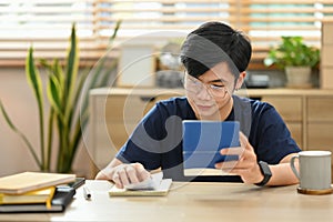 Concentrated man using calculating money bank loan and managing expenses finances in living room