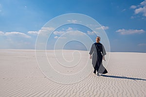 Concentrated man is walking through the desert