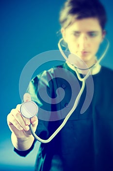 Concentrated medic with stethoscope photo