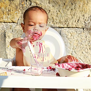 Concentrated messy baby boy playing with water