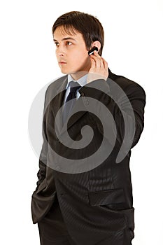 Concentrated modern businessman with handsfree