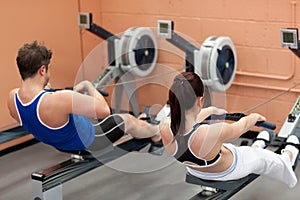 Concentrated people using a rower