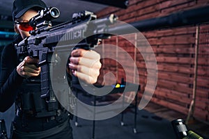 Concentrated professional shooter using a telescopic sight for target shooting