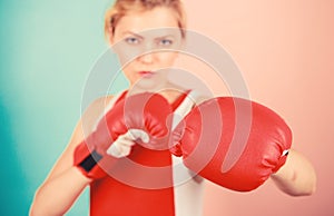 Concentrated on punch. Woman boxing gloves focused on attack. Ambitious girl fight boxing gloves. Female rights. I am