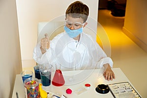 Concentrated schoolboy doing experiment during quarantine time