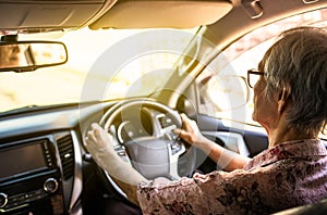 Concentrated senior woman driver hold steering wheel steady using slow speed to avoid accidents,asian elderly people driving