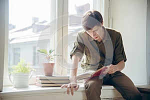 Concentrated serious young man read book