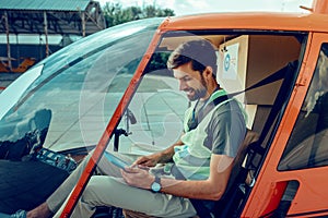 Concentrated short-haired man checking planed rout on his tablet