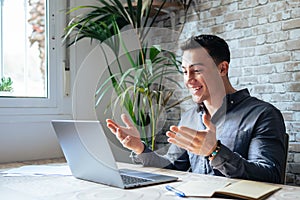 Concentrated skilled millennial caucasian businessman in glasses wearing headphones with mic, taking part in online web camera