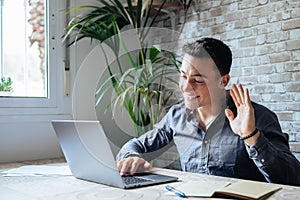 Concentrated skilled millennial caucasian businessman in glasses wearing headphones with mic, taking part in online web camera