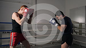 Concentrated sportsmen fighting at boxing ring