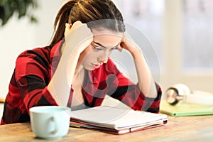 Concentrated student studying memorizing notes at home photo