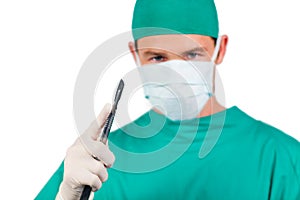 Concentrated surgeon holding a scalpel photo