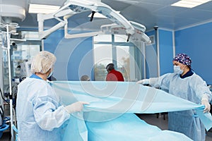 Concentrated Surgical team operating a patient in an operation theater