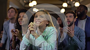 Concentrated team supporters cheering for goal, sport fans entertainment, joy