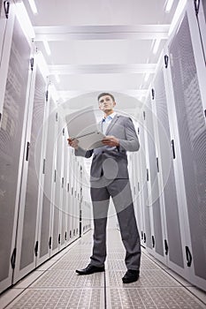 Concentrated technician in suit standing