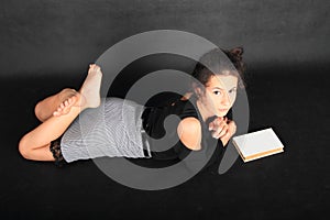 Concentrated teenage schoolgirl with book