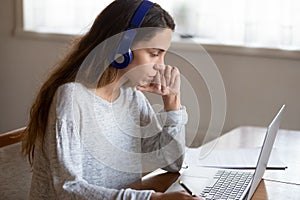 Concentrated woman distant worker taking part at virtual conference