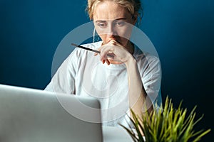 Concentrated Woman Looking At Laptop Screen. Education, Online shopping, Remote Work And Other Meanings Concept